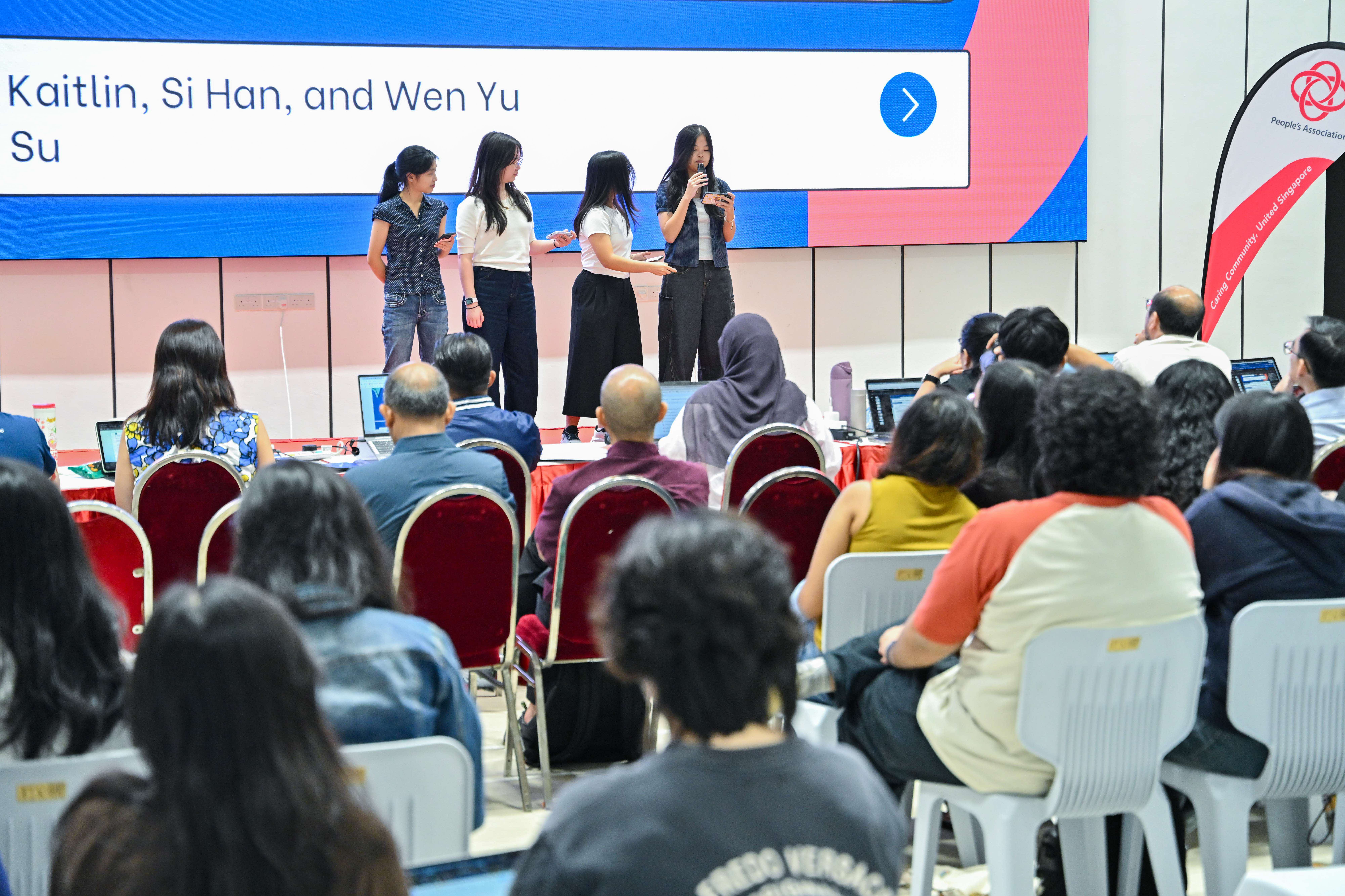 Four students explaining to the audience and panel of judges